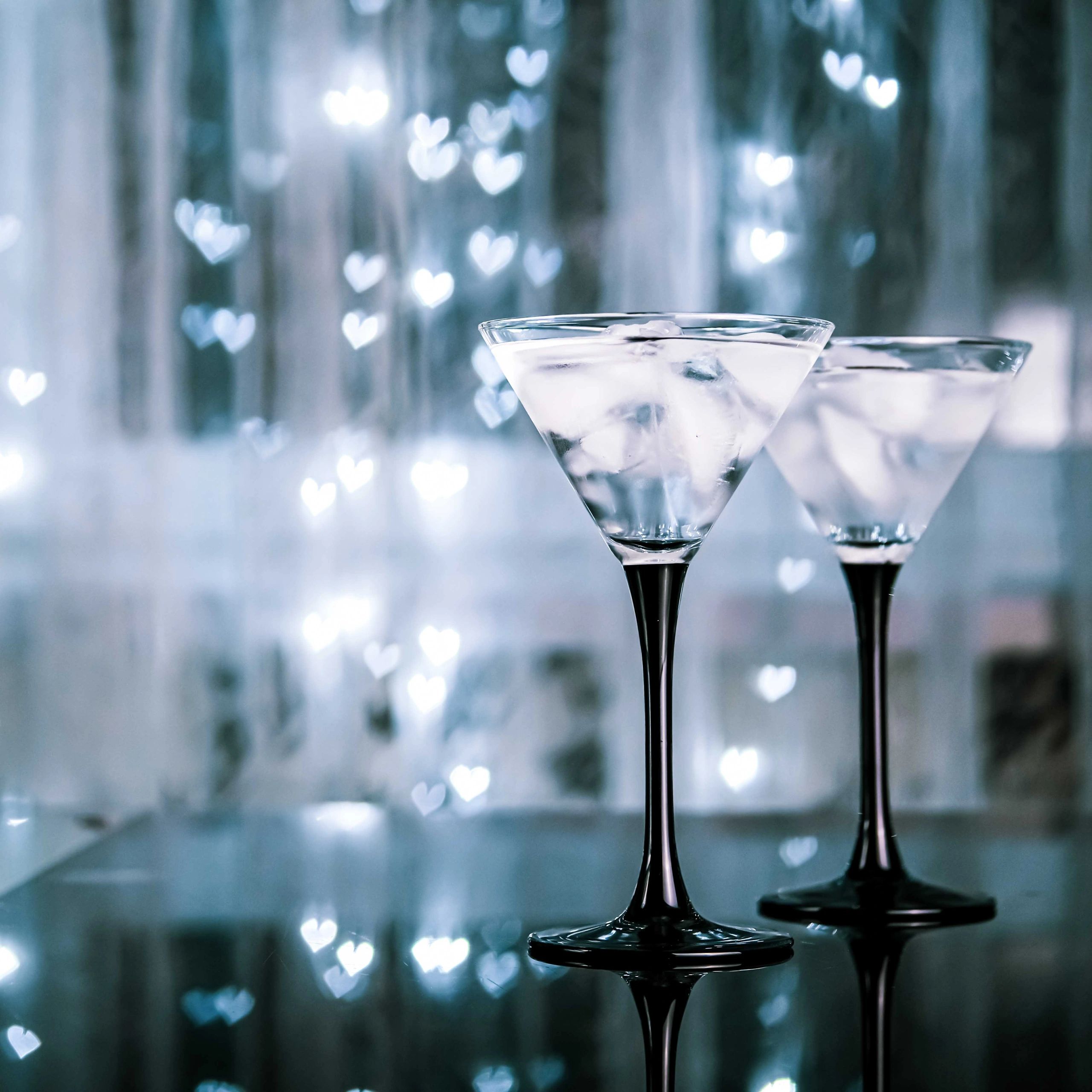 Cocktail glasses against a dark evening backdrop