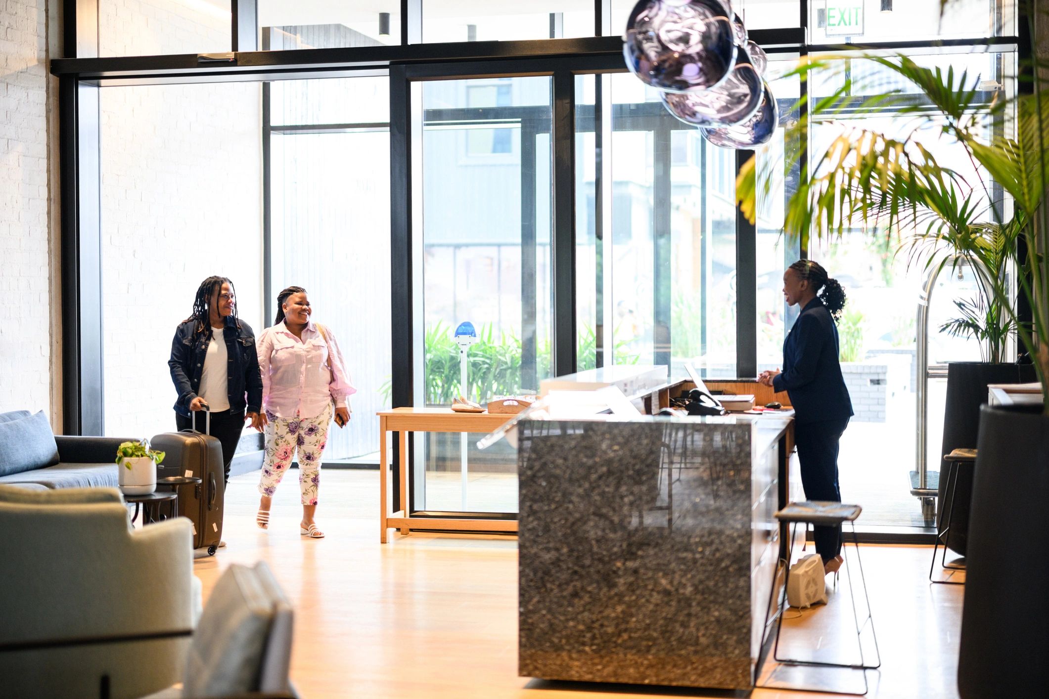 Travelers arriving in a stylish hospitality interior